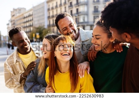 United multiracial group of young student friends having fun together outdoor. International friendship lifestyle concept