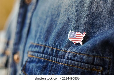 United State Of America Pin Is Pinned On Blue Jeans Jacket. USA Patriotism Concept.