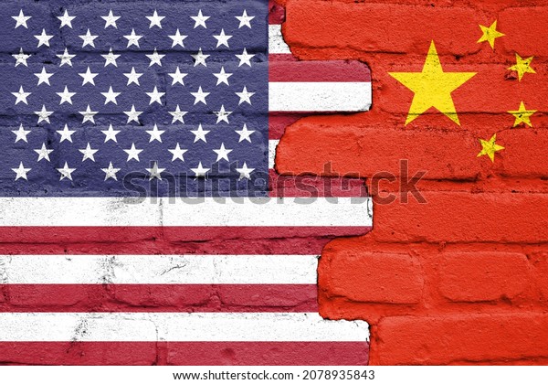 United States of America and China\
flags painted on the brick wall. USA and China war\
concept