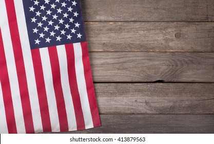 United States of America flag hanging on a rustic wooden background with copy space