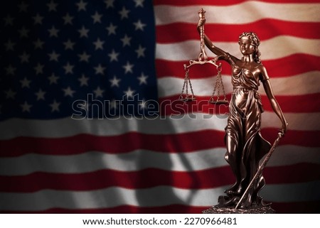 United States of America flag with statue of lady justice and judicial scales in dark room. Concept of judgement and punishment, background for jury topics Foto d'archivio © 
