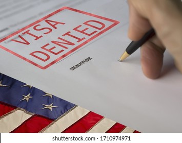 United States of America Visa Document with the mention denied, with USA flag in the background. - Shutterstock ID 1710974971