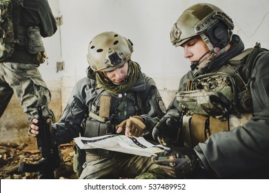 United States Army Rangers During The Military Operation And  Looking At The Map