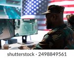 United States army soldier presenting his salute in government operations room, working on intelligence gathering from servers breach. Military personnel on duty during cyber warfare.