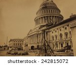 United States Capitol Building in 1863, showing the dome under construction. In the foreground are pre-formed cast-iron metal facings for the new dome. Photo by Andrew J. Russell.