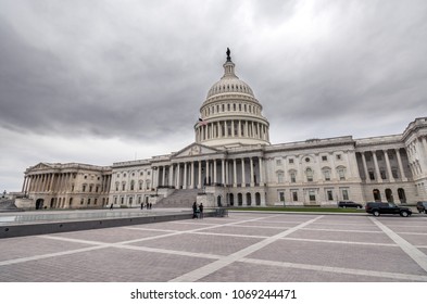 The United States capitol building with dark sclouds above