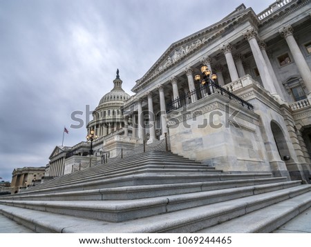 The United States capitol building with dark sclouds above