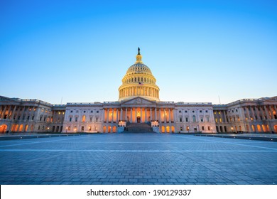 The United States Capitol Building With The Dome Lit Up At Night. 