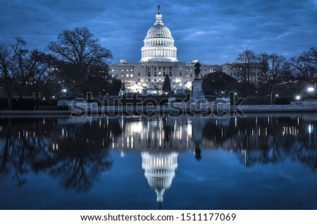 United States Capitol Building at night with mirror reflection over the reflection pool - Washington DC, United States of America