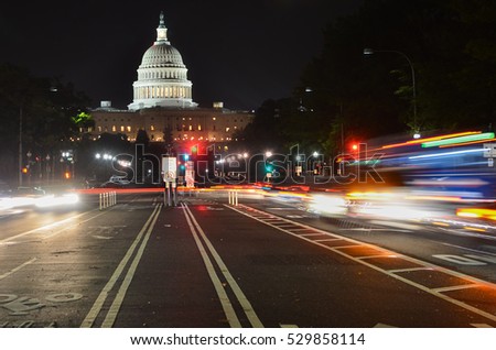 The United States Capitol building at night as seen from Pennsylvania Avenue with car lights trails - Washington DC, United States
