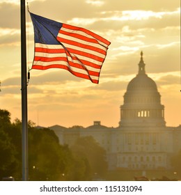 United States Capitol Building Silhouette And US Flag At Sunrise - Washington DC