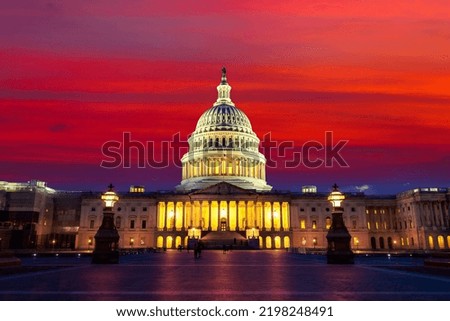 The United States Capitol building at sunset at night in Washington DC, USA