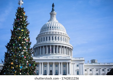 United States Capitol Building In Washington, DC,with Festive, Decorated Christmas Tree On A Sunny Day With Blue Sky