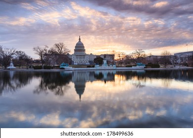 The United States Capitol building in Washington DC at sunrise mirrored in the reflecting pool