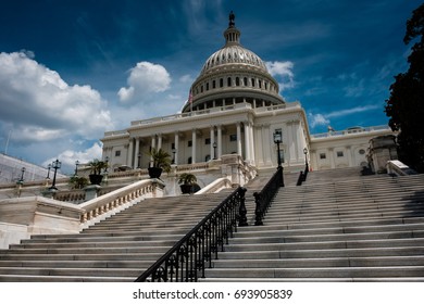 United States Capitol building west steps under a cloudy blue sky, Washington, DC, USA