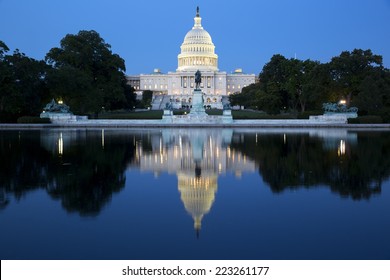 United States Capitol, Government in Washington, D.C., United States of America. Illuminated at night with reflection showing in reflecting pool. 