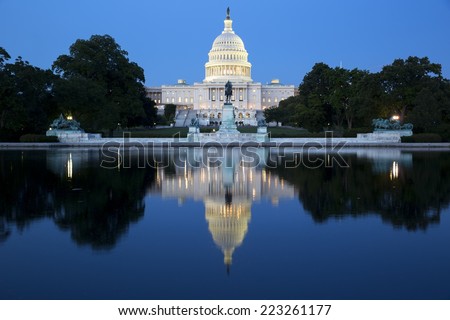 United States Capitol, Government in Washington, D.C., United States of America. Illuminated at night with reflection showing in reflecting pool. 