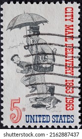 UNITED STATES - CIRCA 1963: A Postage Stamp From UNITED STATES , Showing A Postman With Mail Bag And Umbrella. Boy With Dog Runs Past. Letter Carrier, 1863 .Circa 1963