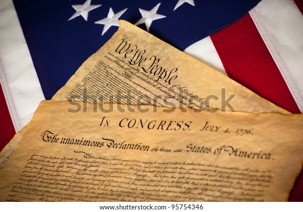 the United States Constitution\
and Declaration of Independence on a Betsy Ross Flag\
background