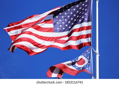 United States flag with Ohio state flag brilliant blue sky