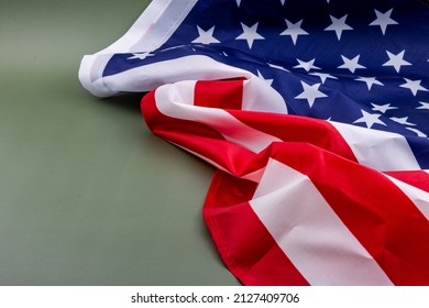 United States Flag On A Green Background, A Flag Of The United States, Against An Olive Green Background With A Blank On The Left Side