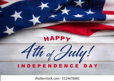 United states flag on white, weathered clapboard background with july 4th greeting - Shutterstock ID 1124678681