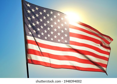 United States Flag Waving On The Wind In Front Of Sun