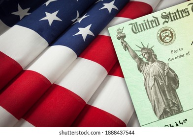 United States IRS Stimulus Check Resting On American Flag.