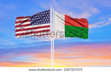 United States and Madagascar two flags on flagpoles and blue cloudy sky . Diplomacy concept, international relations