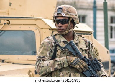 United States - March 29 2022: African American United States Marine Corps Soldier With Sunglasses, Shotgun Or Rifle And Armored Vehicle Humvee, USA Or US Army Troops Ready For Drills Or War