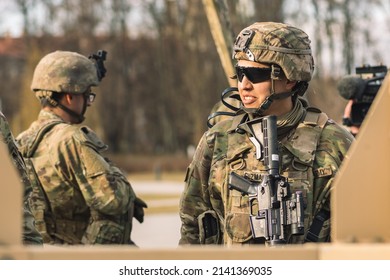 United States - March 29 2022: Latin American United States Marine Corps Soldier With Shotgun Or Rifle, Helmet And Military Vehicles On Background, USA Or US Army Troops Ready For Drills Or War