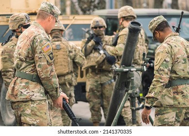 United States - March 29 2022: United States Marine Corps Soldiers With Helmets And Shotguns Or Rifles Preparing A Mortar, USA Or US Army Troops Ready For Battle, Drills Or War In The City