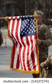 United States - March 29 2022: United States Marine Corps Soldiers Roll Up American Flag, USA Or US Army Troops Ready For Drills Or War, Vertical