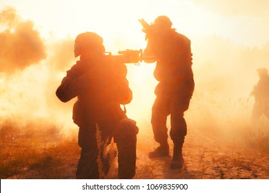 United States Marines In Action. Military Equipment, Army Helmet, Warpaint, Smoked Dirty Face, Tactical Gloves. Military Action, Desert Battlefield, Smoke Grenades