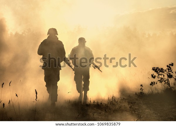 United States Marines\
in action. Military equipment, army helmet, warpaint, smoked dirty\
face, tactical gloves. Military action, desert battlefield, smoke\
grenades