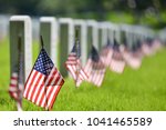 United States National flags and headstones in National cemetery - Circa Washington DC USA