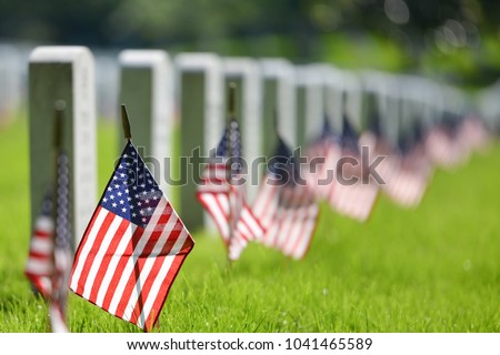 United States National flags and headstones in National cemetery - Circa Washington DC USA