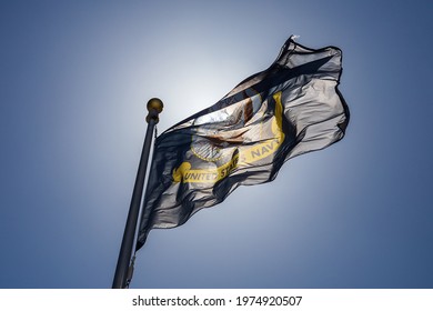 United States Navy Flag With Blue Sky And Sunlight.