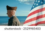 United States Navy Veteran Is Moved Looking At The Ocean With American Flag