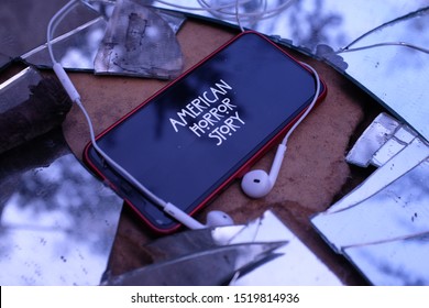 United States New York. Tuesday, October 1, 2019, Headphones And Iphone 11 Pro With The American Horror Story Logo. American Horror Story Is A Drama And Horror Television Series.