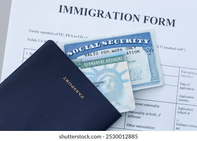 United States passport, social security card and permanent resident (green) card on immigration form. Application to register permanent residence.