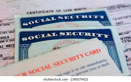 United States Social Security cards with birth certificate background. Concept for life, retirement or death or Government documents and identification. 