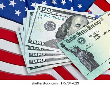 United States Treasury Check With 100 Dollars US Currency And American Flag. Coronavirus Economic Impact Stimulus Payments Or IRS Tax Refund. 