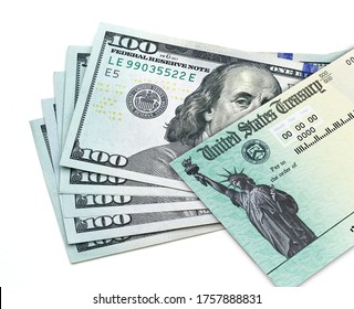 United States Treasury Check With US 100 Dollar Bills Isolated On White Background. Coronavirus Economic Impact Stimulus Payments Or IRS Tax Refund. 