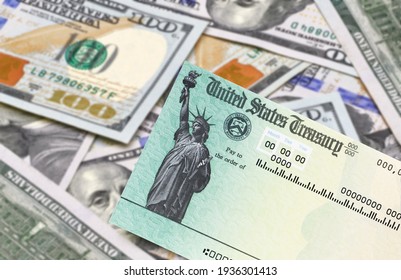 United States Treasury Check With US Currency And Covid Mask. Coronavirus Economic Impact Stimulus Payments Or IRS Tax Refund. 