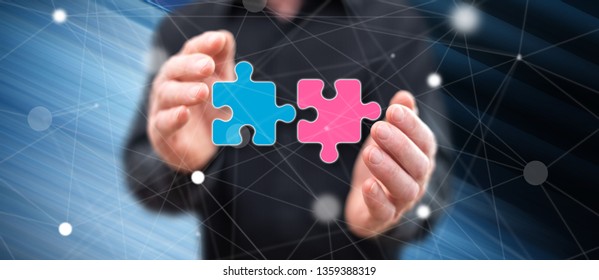 Unity concept between hands of a man in background - Shutterstock ID 1359388319
