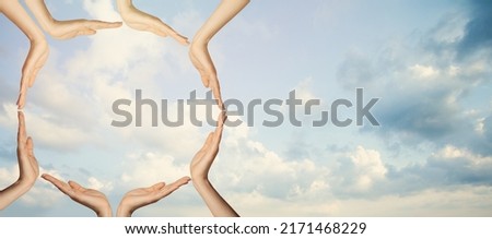 Unity concept. Hands against sky clouds background