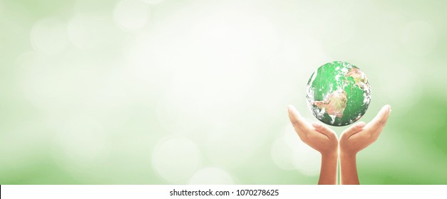 Unity Concept: Human Hands Holding Earth Global Over Blurred Green Nature Background. Elements Of This Image Furnished By NASA