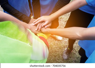 Unity hand ,Blur image of soccer players meet hands to beat other teams. - Powered by Shutterstock