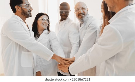 Unity in Science: Multiracial Lab Team Joining Hands for Collaboration and Success - Powered by Shutterstock